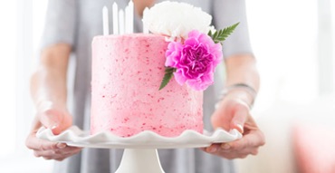 a pink cake with flower on top of it